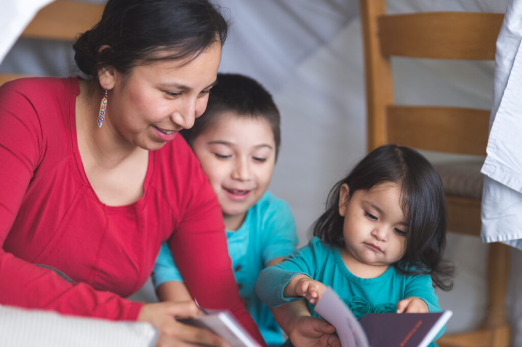 Native American mom reads with her kids