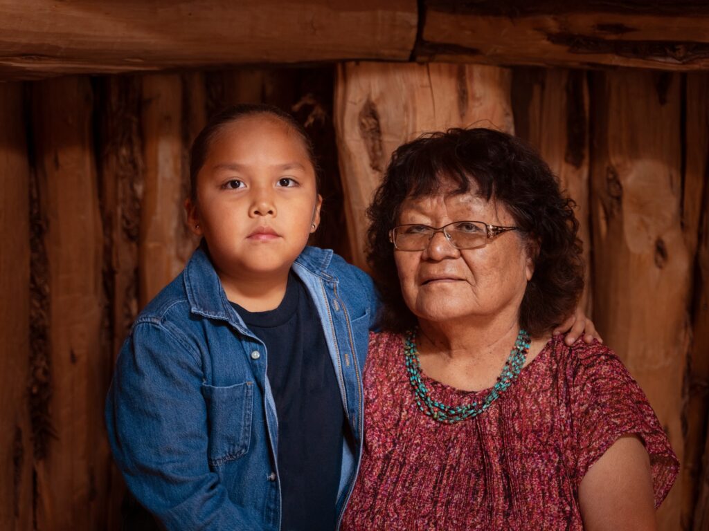 Navajo Grandma and grandson in traditional hogan