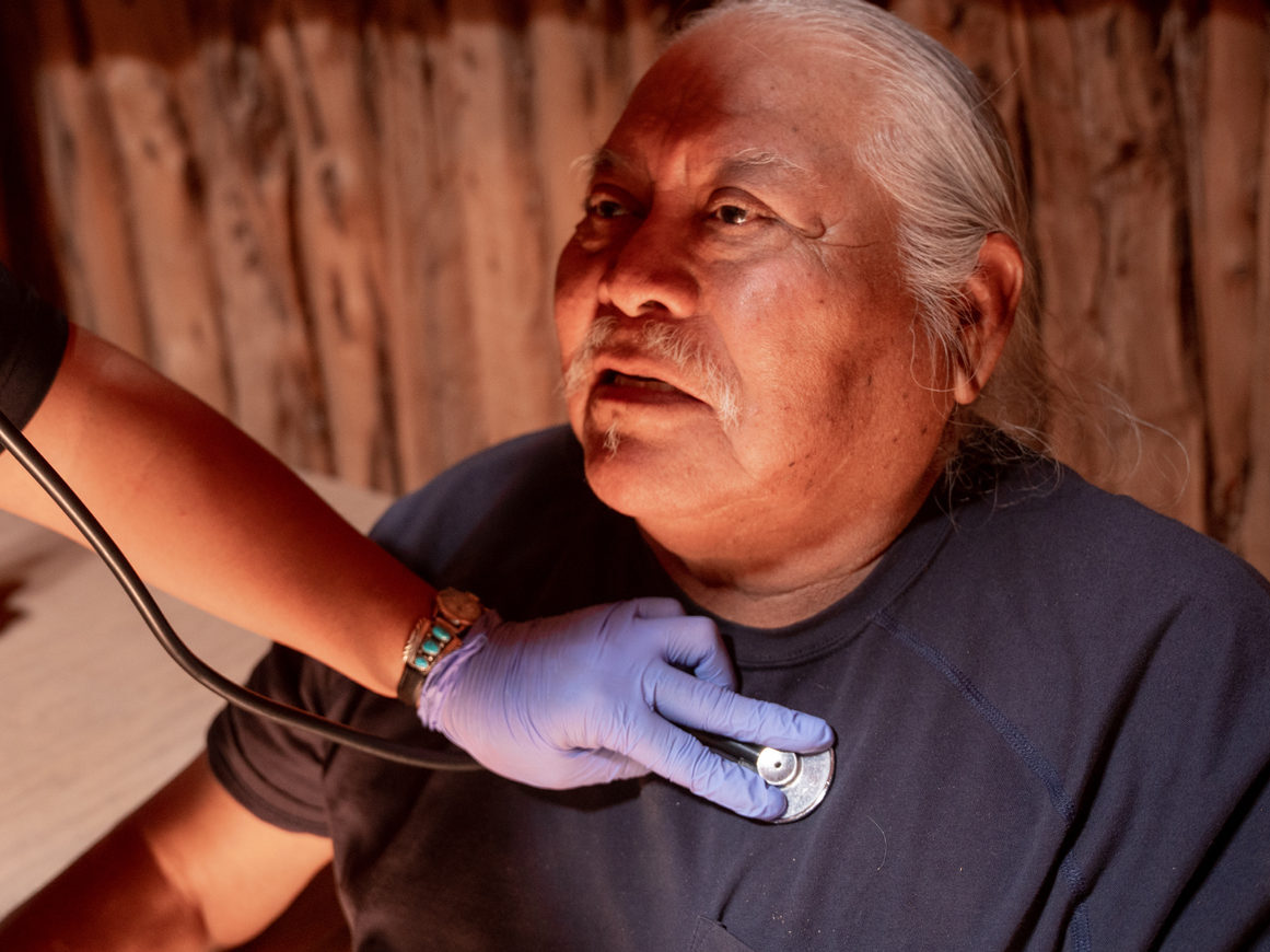 Medical professional checking an elderly patient